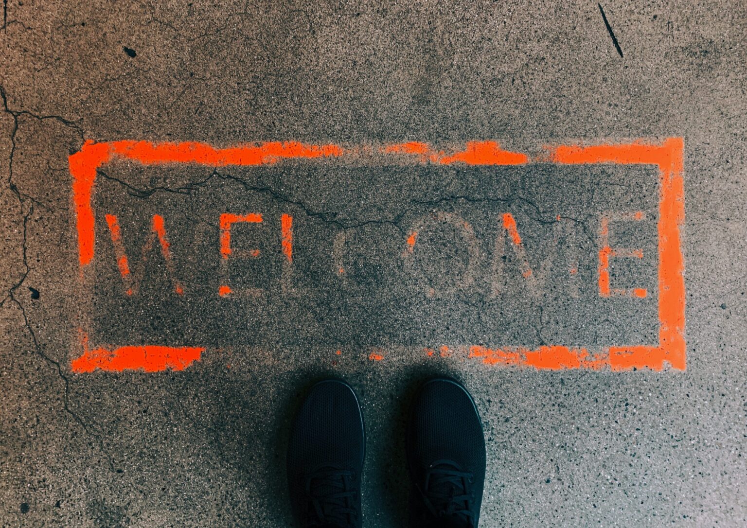 faded welcome stamp on concrete