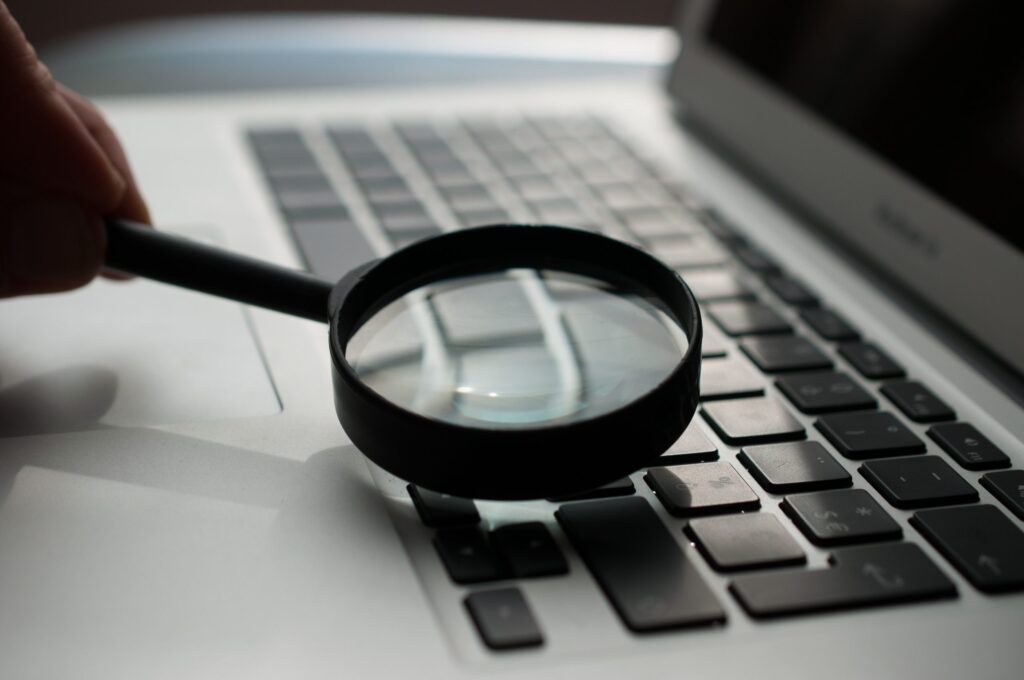 magnifying glass searching a keyboard