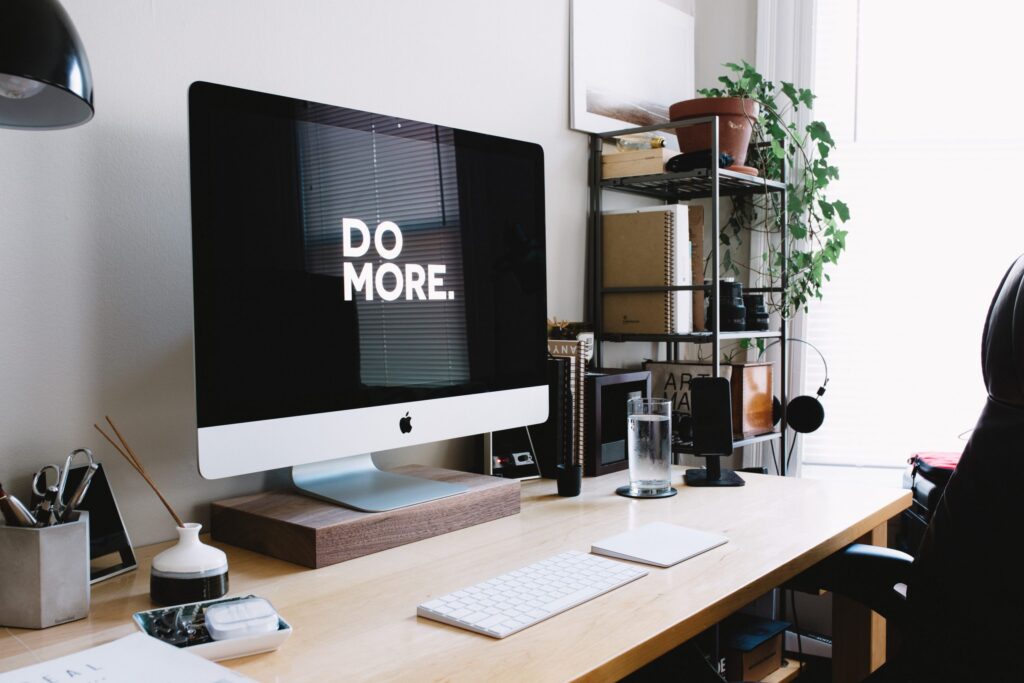a home working set up with a monitor that reads "do more"