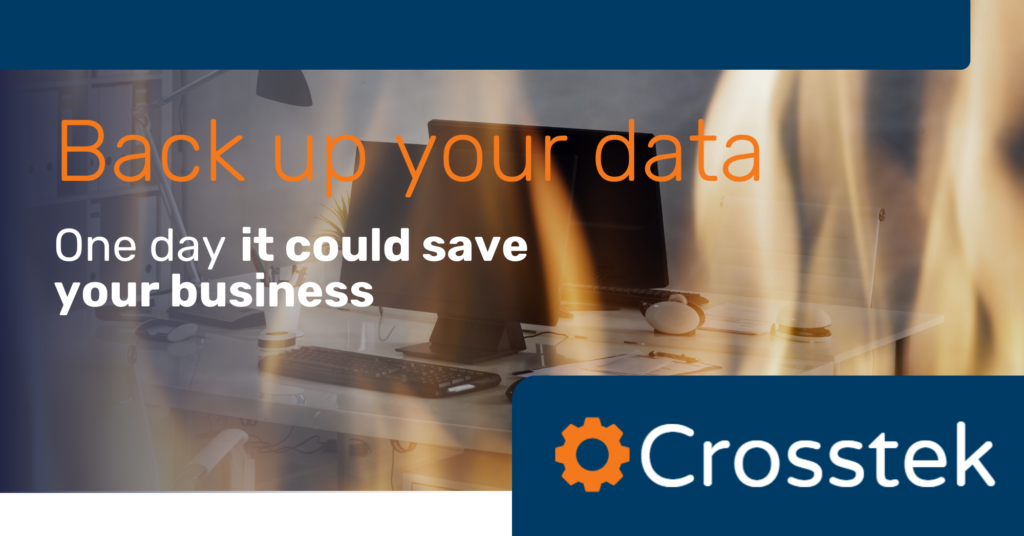 data backup graphic overlaid on a photo of flames licking a work desk