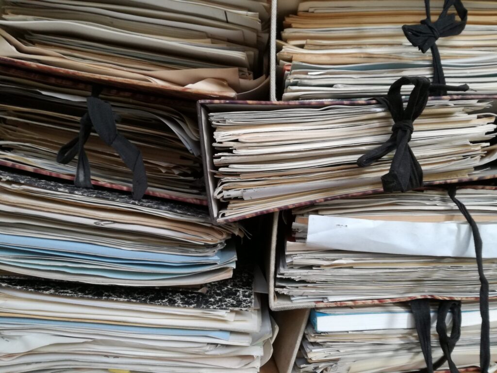 many files stuffed full, in a pile