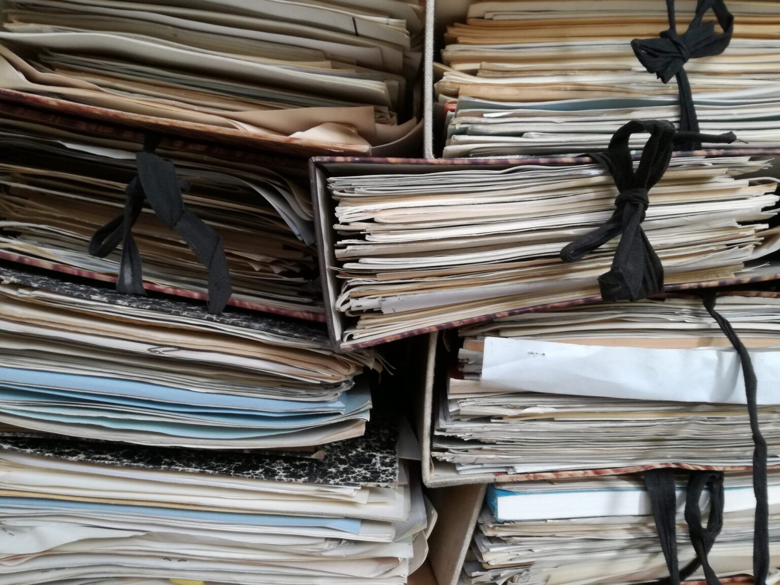 many files stuffed full, in a pile