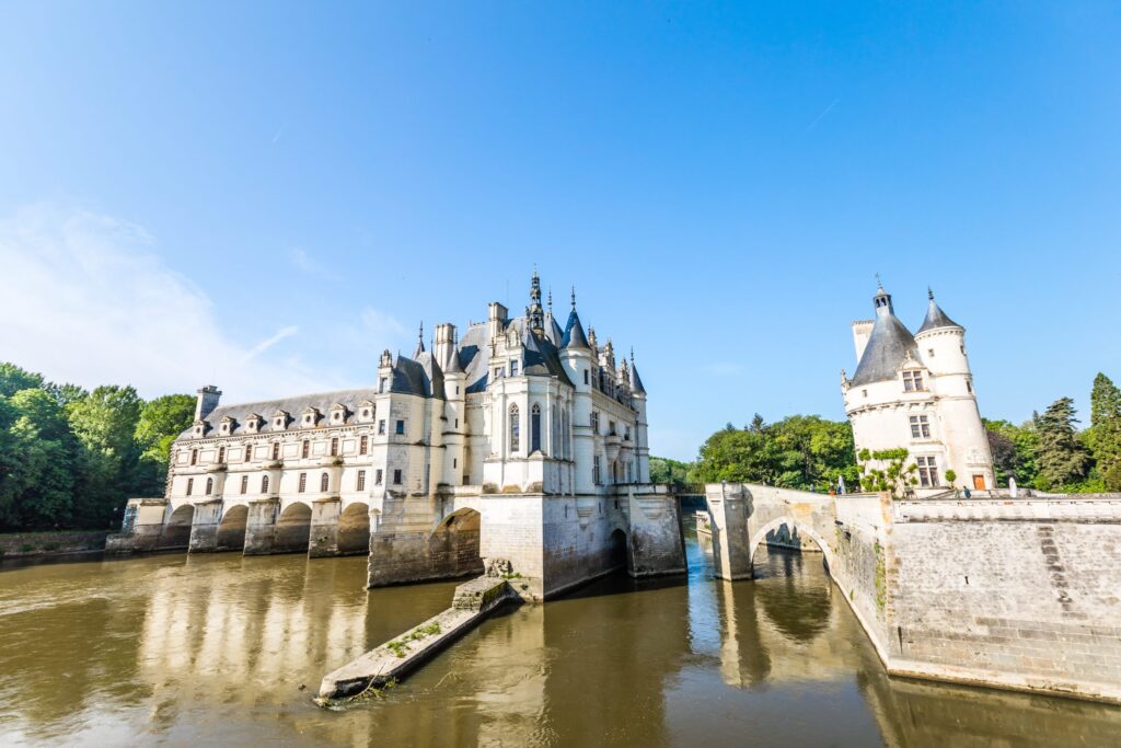 a beautilful castle surrounded by a moat and drawbridge