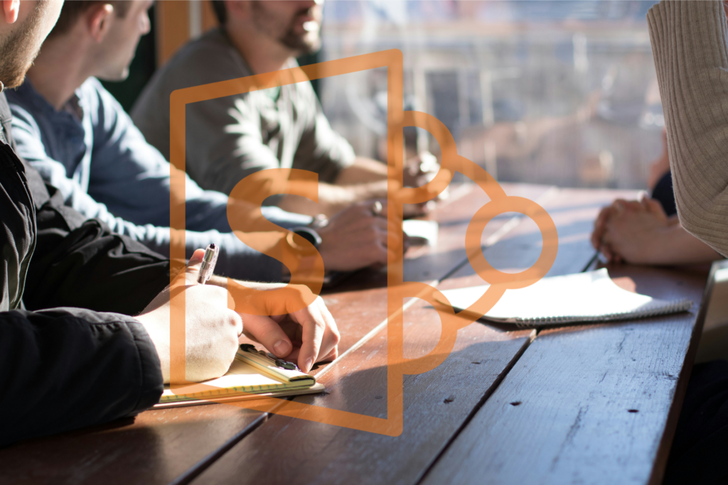 microsoft sharepoint logo over a photo of team collaboration