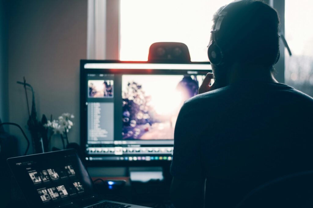 a home worker in front of several screens