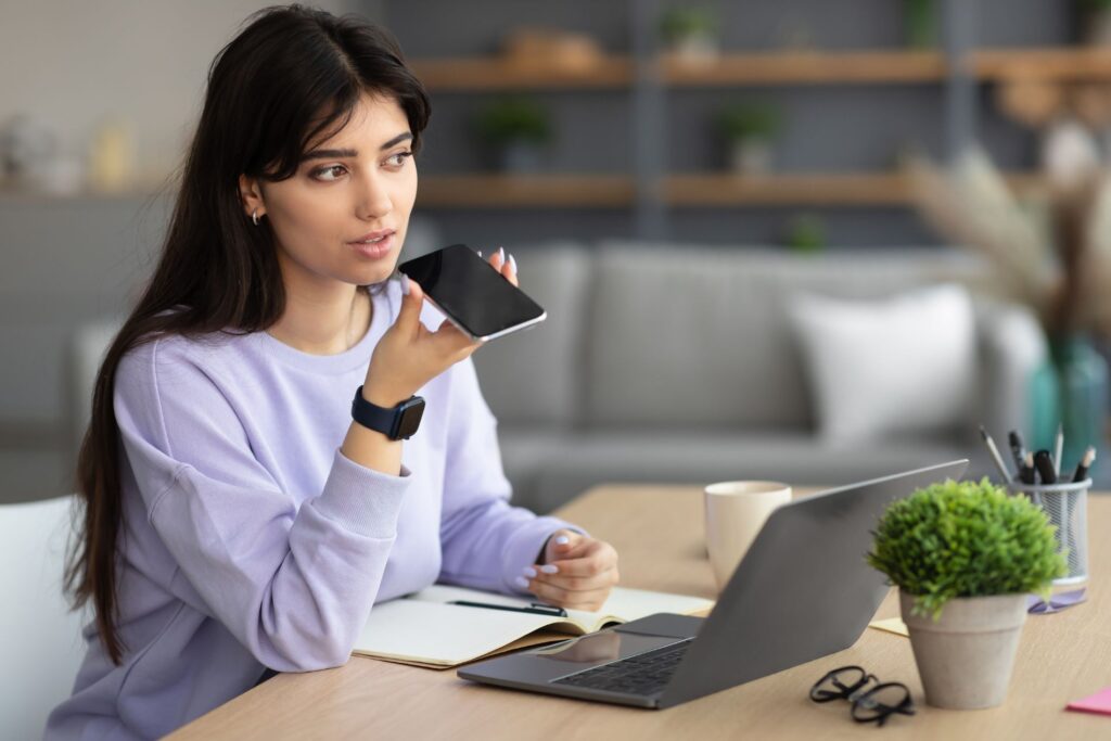 a woman on the mobile phone at her laptop