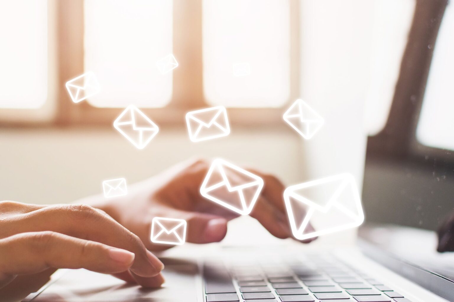 email icons floating around a laptop computer
