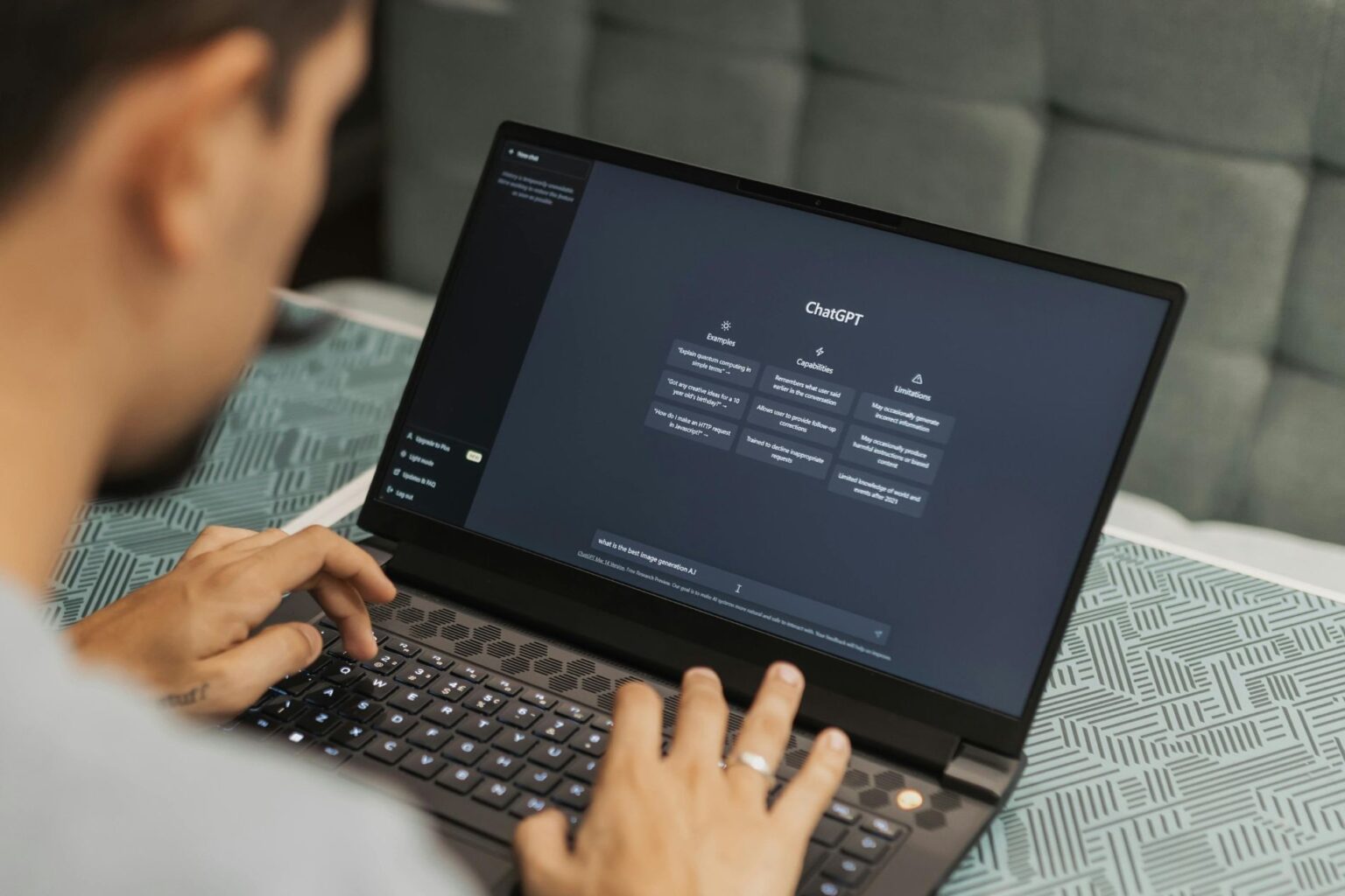 a man works at a laptop with ChatGPT search page displayed